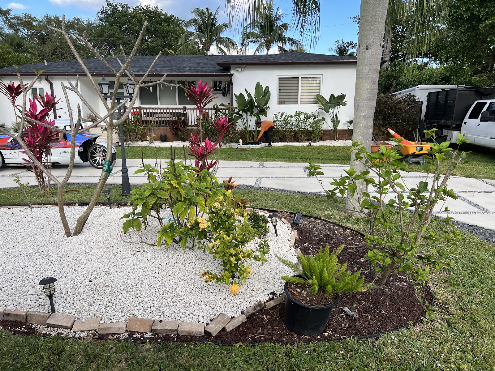 Landscaping crew maintaining a residential lawn in Miami